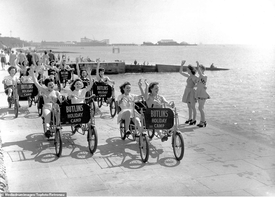 A group of delighted women wave to spectators while riding four-wheel novelty tandem cycles down Clacton-on-Sea's promenade. The charming black and white photos were recently unearthed in TopFoto's digital archives
