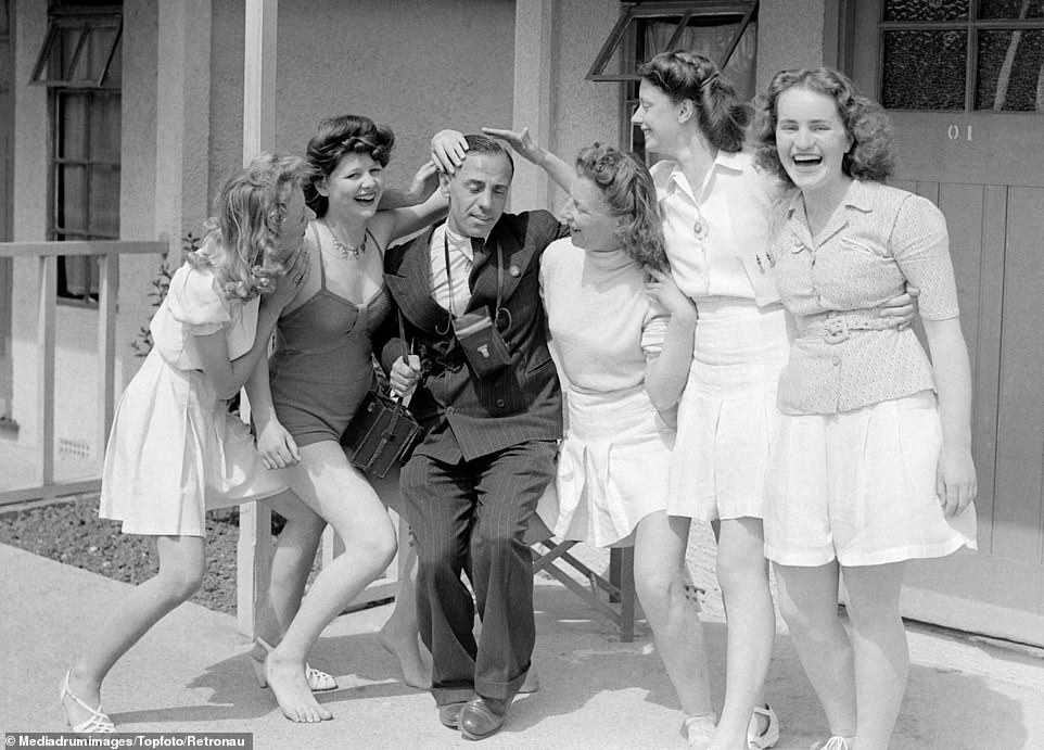 Fun in the sun outside a cabin in Clacton-on-Sea's holiday camp in Essex with five women and one man posing for a black and white photograph in 1949, in the recently unearthed images