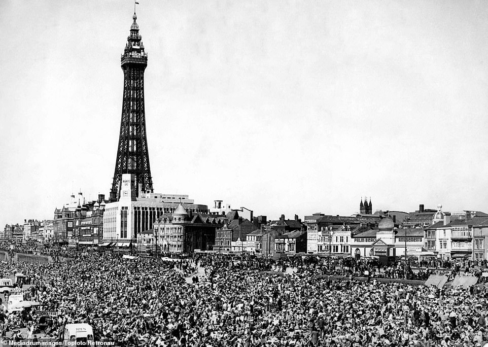 Thousands of holidaymakers are seen enjoying the first real break of the summer on Blackpool's beaches, with the famous Blackpool Tower in the background in 1948. The British seaside holiday hit its acme in the 50s and 60s