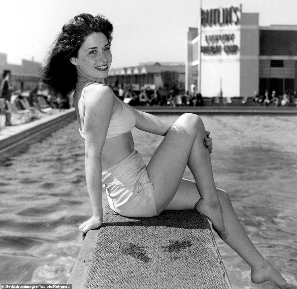 A woman poses for a photograph on a diving board at Butlin's holiday camp in Clacton-on-Sea, Essex. The sixties was the company's most successful decade with a further three resorts opened at Bognor Regis, Minehead and Barry Island